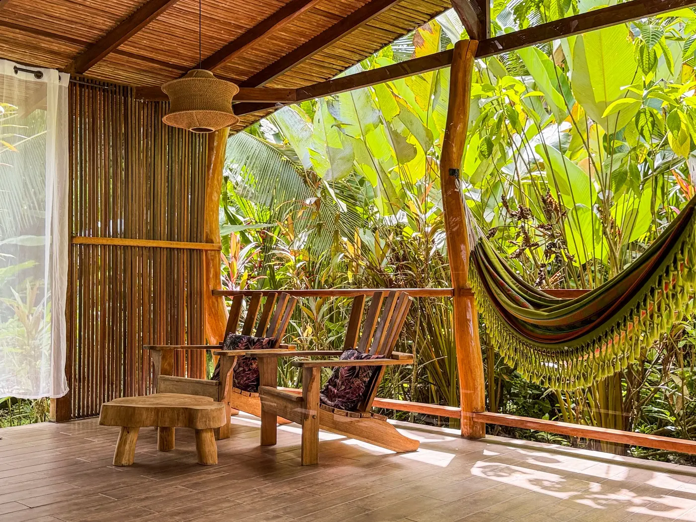 Covered outdoor terrace with hammock and lounge chairs